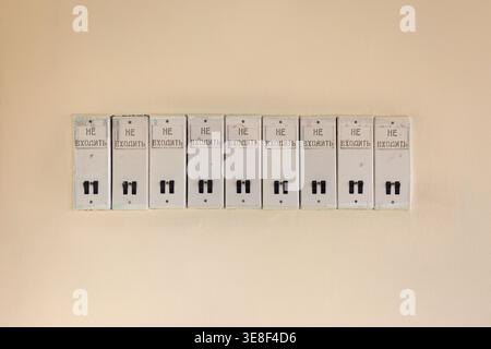 A row of old Soviet-era electrical switches with original Russian "HE ВХОДИТЬ" (Do Not Enter) warning text. Authentic USSR industrial aesthetics in an Stock Photo