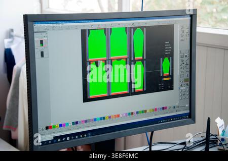 Computer monitor displaying garment pattern layout in design software, used for textile production and apparel manufacturing, highlighting digital wor Stock Photo
