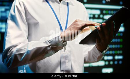 Admin in cloud computing business walking through server clusters used for computationally intensive tasks such as weather simulations. Supervisor doing yearly equipment inspection, close up Stock Photo