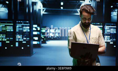 Engineer in cryptocurrency server farm with specialized hardware using Blockchain technology for crypto mining. Fintech specialist using asic rigs to solve complex computational problems Stock Photo