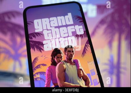 Paris, France - April 14, 2026: A smartphone screen displays the official Grand Theft Auto VI (GTA 6) logo and artwork featuring the main characters. Stock Photo