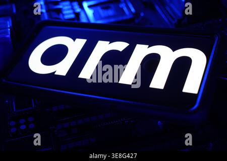 ARM Semiconductor Technology Chips Manufacturing Company Logo on Screen With Stock Financial Chart Performance in Background Stock Photo