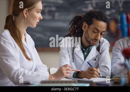 Adult Science Students Collaborating during Classroom Lab Study Stock Photo