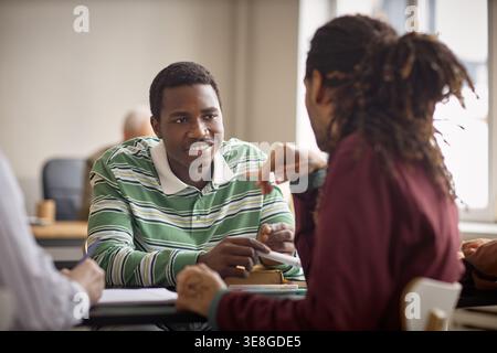Black Teenage Students Collaborating in Classroom Discussion Stock Photo