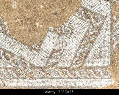 Top view of ancient Roman mosaic floor tiles with geometric patterns and guilloche braided motifswhite and red colors Roman Ruins of Milreu portugal Stock Photo