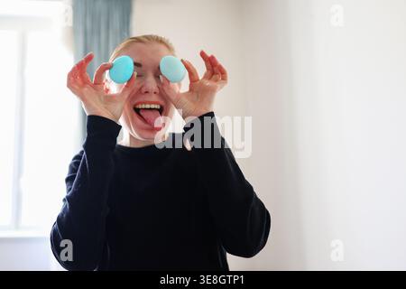Happy woman with colored eggs, fun Easter preparation and positive эмоtion. Stock Photo
