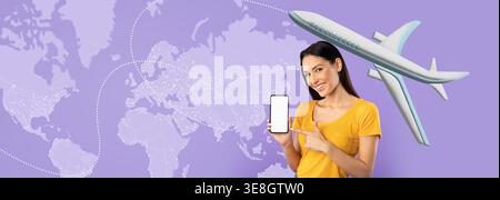 A Woman Stands Smiling, Pointing at Her Phone While Displaying a World Map With an Airplane Graphic Stock Photo