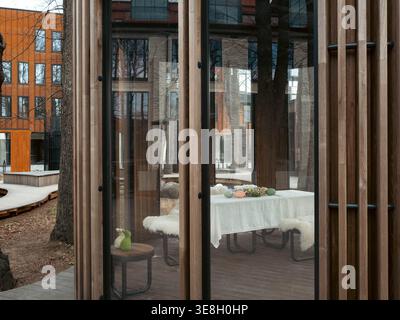 Easter table setting in a modern glass pavilion with wooden slats in Kalamaja district, Tallinn, Estonia, spring Stock Photo