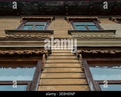 Ornate wooden facade with carved window frames on a historic house in Kalamaja district, Tallinn, Estonia Stock Photo