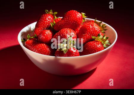strawberry bowl on red background Stock Photo