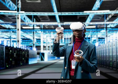 VR headset gear, identifying errors and engineer in data center monitoring system performance. Implementing optimizations, virtual reality technology and admin in server farm improving electronics Stock Photo