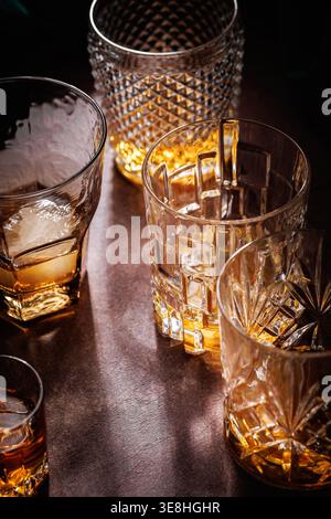 Crystal Whiskey Glasses with Amber Drink and Dramatic Light Stock Photo