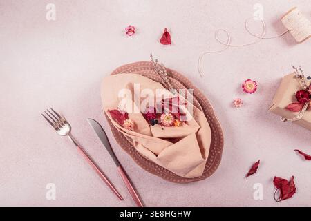 Process of decorating festive autumn table setting with dried flowers. Stock Photo
