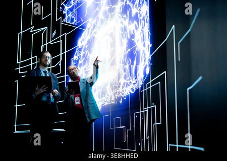 Autonomous AI agent writing complex code under engineering team supervision. IT staff members use devices to track the self generating architecture of advanced artificial intelligence model Stock Photo