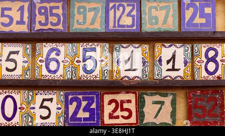 297 Ceramic plaques for house numbering, both fired and glazed, displayed at a shop in the Souk Semmarine, in the Medina (old town). Marrakesh-Morocco Stock Photo
