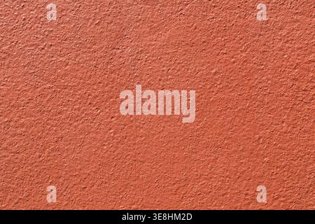 Orange stucco wall texture background. Close up of bumpy painted terracotta plaster surface Stock Photo