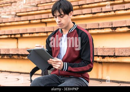 Young man studying with tablet and digital pen Stock Photo