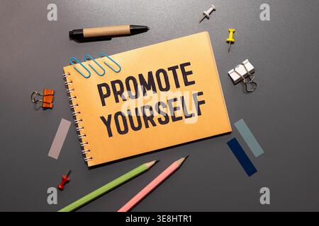 PROMOTE YOURSELF text written on a notebook with chart Stock Photo