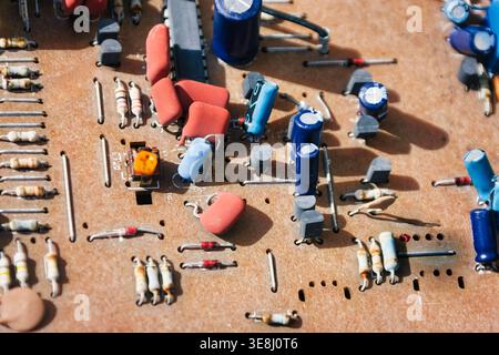 vintage Electronic printed circuit board featuring various resistors capacitors integrated circuits old hardware components technology infrastructure Stock Photo