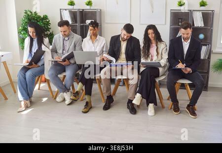 Business Team Seated In Row At Office Meeting Stock Photo