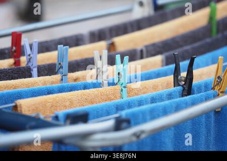 Clothes drying on a rack outside in sunny weather Stock Photo