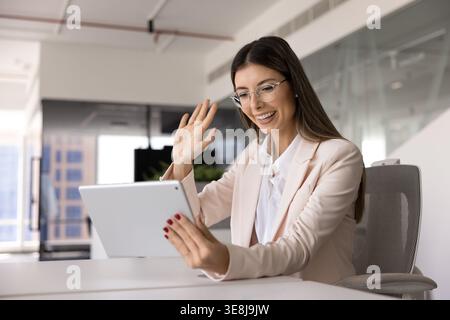 Young businesswoman engaged in video call using digital tablet Stock Photo