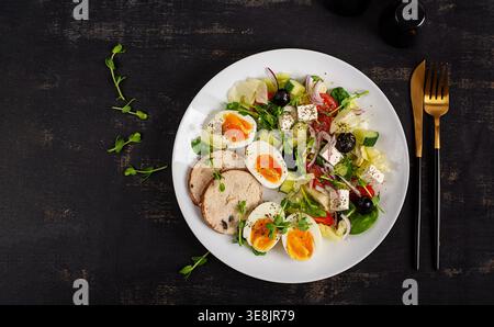 Healthy Salad with Boiled Eggs and Vegetables on Dark Background. Top view Stock Photo
