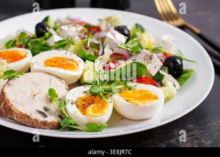 Healthy Salad with Boiled Eggs and Vegetables on Dark Background Stock Photo