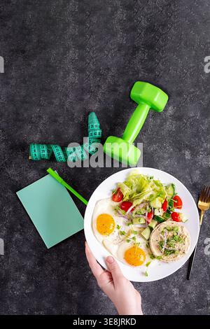 Diet plan concept with healthy meal, notebook and dumbbell, top view Stock Photo