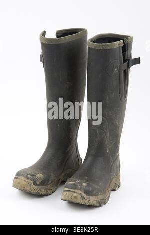 Muddy wellies on a white background Stock Photo