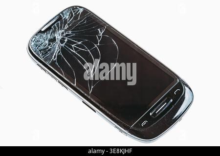 Broken smartphone with shattered glass screen on white background Stock Photo