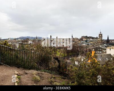 Wide panoramic view over Edinburgh showing historic buildings, castle, spires and cemetery from a hilltop viewpoint. Stock Photo