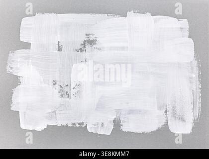 white acrylic paint brushstrokes on grey kraft paper. hand painted texture. Stock Photo