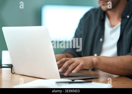 Hands, laptop and typing with remote work from home with project management, admin and review on sofa. Person, virtual assistant and notes for Stock Photo
