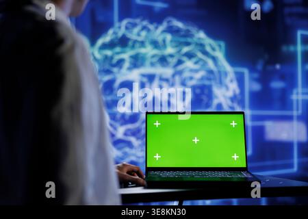 Admin using mockup device for artificial intelligence computing simulating human brain through self learning algorithms. Employee with isolated screen laptop, working with AI deep neural networks Stock Photo