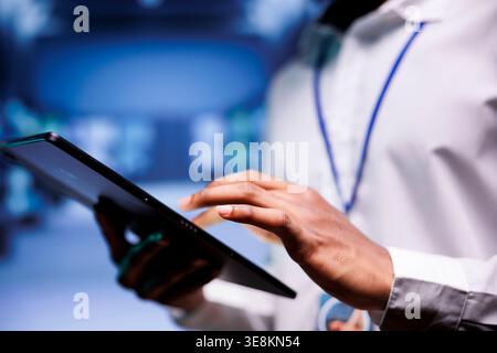 Expert in cryptocurrency server farm with dedicated hardware using Blockchain technology for crypto mining. Fintech professional using asic rigs to solve intricate computational problems, close up Stock Photo
