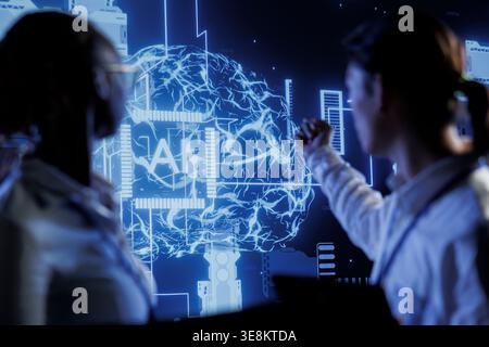 Computer scientists brainstorm ways to use AI cognitive computing to extract usable information from complex data. Data center employees implement artificial intelligence to process massive datasets Stock Photo