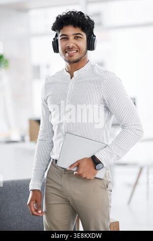 Headphones, portrait and man with tablet in office, professional and confident for software development. Smile, tech or developer with pride for Stock Photo