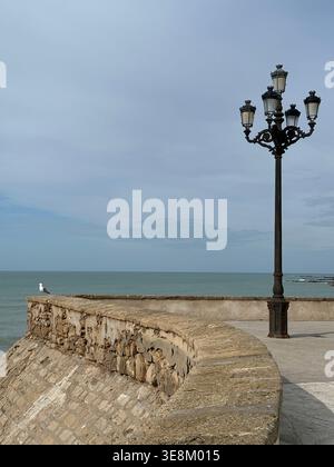 Street lamp post on seafront promenade in Cadiz, Spain Stock Photo