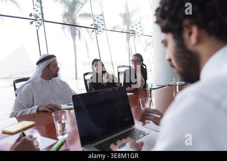 Business meeting in modern boardroom with diverse team discussing strategy and collaboration Stock Photo