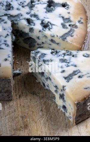 Close up shot of a slice of Forme d'Ambert cheese on a cutting board Stock Photo