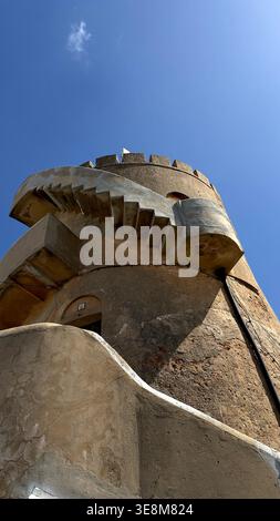 Low angle view of a historic stone watchtower with an external spiral staircase Ferragudo portimao algarve portugal Stock Photo