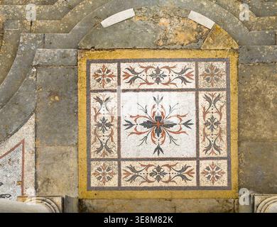 Top view of an ancient Roman mosaic tile floor featuring intricate floral patterns and geometric designs Roman Ruins of Milreu portugal Stock Photo