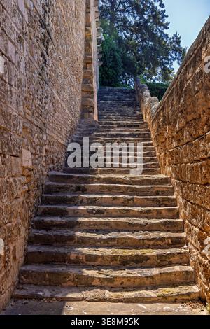 Old stone stair by an old stone building Stock Photo