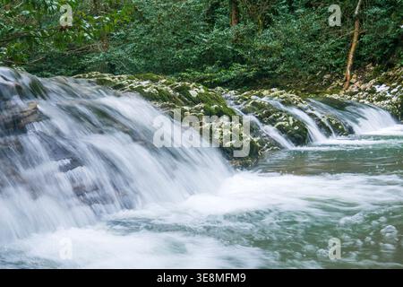 Waterfall in deep forest. Long exposure photo with motion blur. Stock Photo