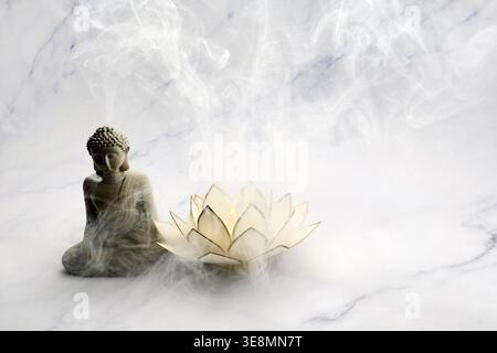 Vesak day. Buddha statue meditating with lotus lamp and spiritual smoke Stock Photo