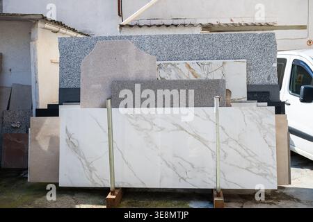 Marble and granite stone slabs display in outdoor construction materials yard Stock Photo
