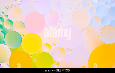 Abstract macro texture with pastel pink, blue, green, and yellow bubbles, soft light background, smooth gradients. Perfect backdrop for topics related Stock Photo