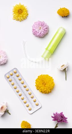 Items related to women's health on a white background with flowers Stock Photo