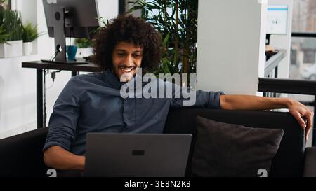 Analyst celebrating successful win in coworking space, feeling proud about business achievement or victory. Professional manager enjoying progress to develop career, job satisfaction. Stock Photo